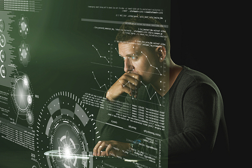 Pensive developer reading information on transparent computer screen