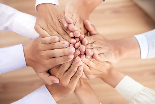 Close-up image of business people keeping their hands together