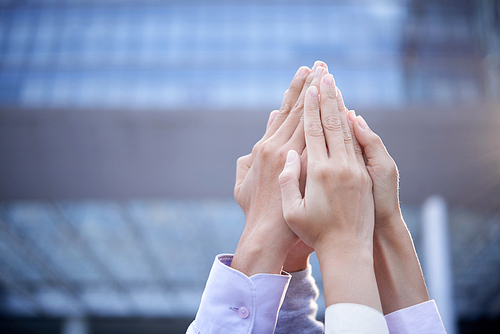 Business coworkers making pyramid with their hands to express determination