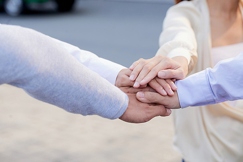 Business team member stacking their hands to express support