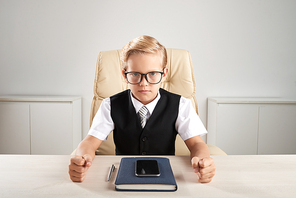 Unhappy little businessman ready to conduct a meeting