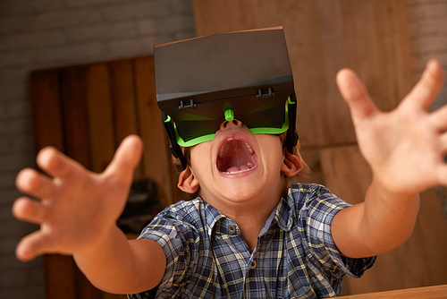 Boy in goggles playing fun video game