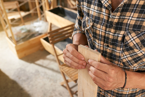 Close-up image of carpenter checking wooden planks