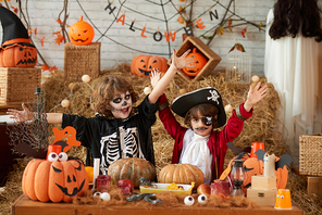 Happy children ready to celebrate Halloween at decorated barn