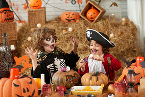 Boy scared of story that his brother is telling him when making decorations