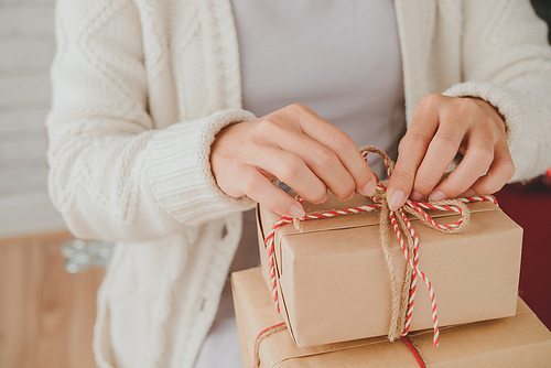 Woman opening her presents on Christmas morning