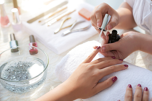 Close-up image of woman having her nails done in beauty salon