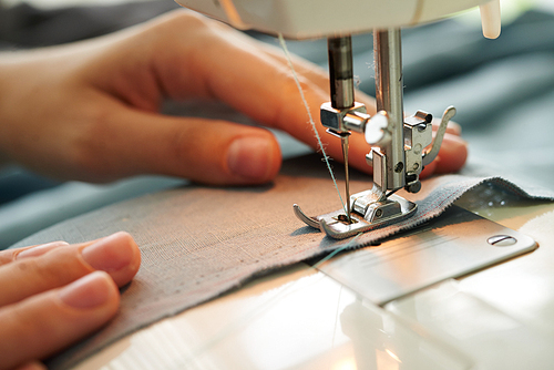 Close-up image of tailor sewing on sewing machine