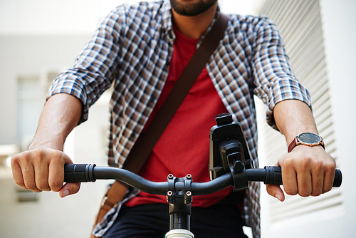 Close-up image of man using navigator when traveling in the city on bicycle