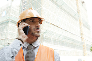 Construction worker calling foreman to discuss process of building of new object