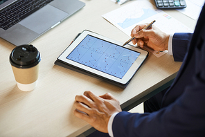 Hands of Entrepreneur analyzing charts with statistics on tablet computer