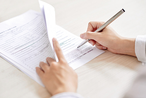 Businesswoman or agent signing agreement or filling in application after negotiating with partner or client