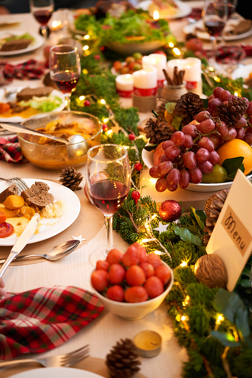 Fruits, wine and various dishes on Christmas dinner table