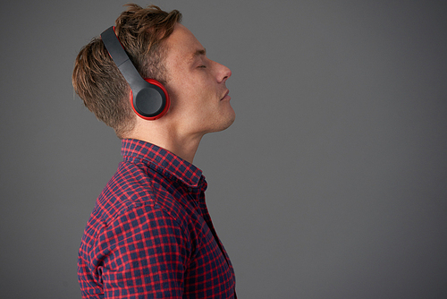 Young man in headphones enjoying good music