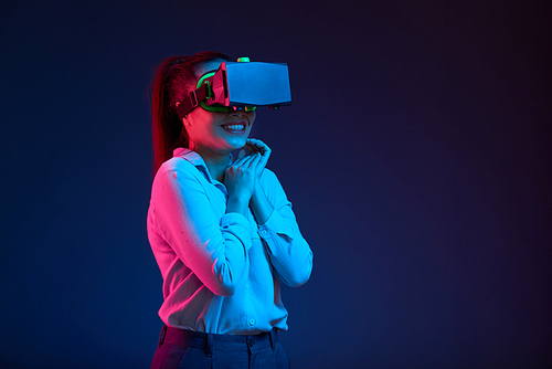 Portrait of excited Asian young woman in virtual reality headset