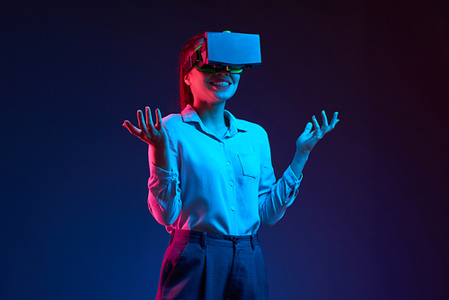 Cheerful smiling Asian business lady using vr glass to communicate with coworkers
