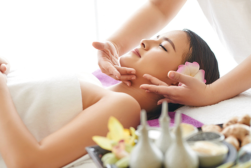 Vietnamese young woman getting spa treatment in spa salon