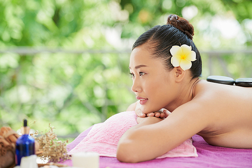 Beautiful Vietnamese young woman relaxing in spa
