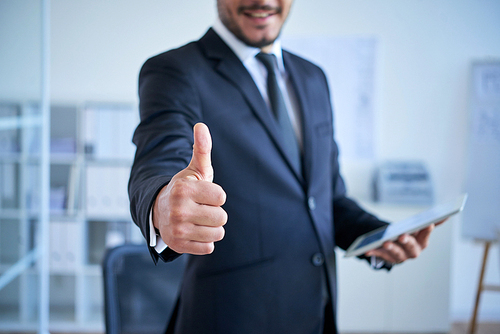 Cropped image of businessman showing thumbs-up to support you