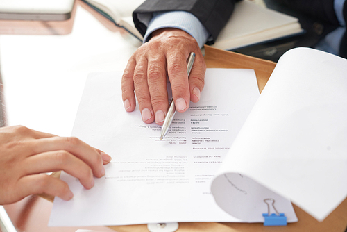 Close-up of business people examining business resume at the table during a job interview
