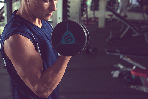 Cropped image of man training with dumbbell