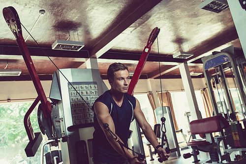 Young man concentrated of exercises for arms