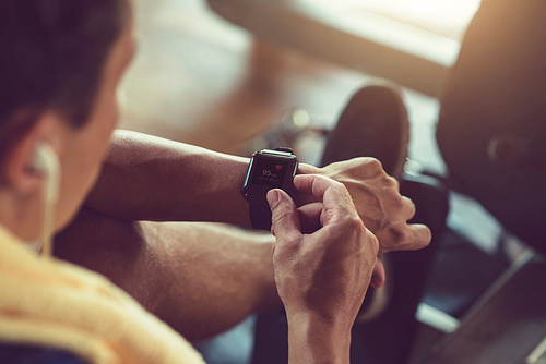 Close-up image of athlete checking pulse via smart watch