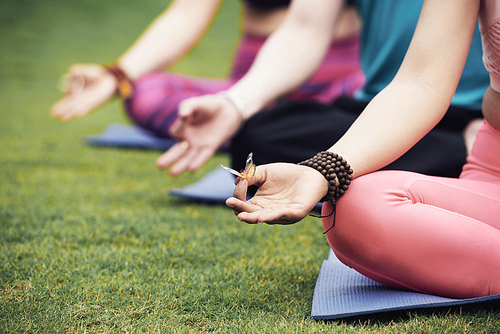 Butterfly on hand of meditating woman