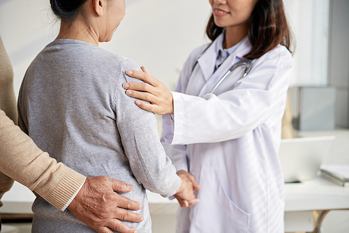 Cropped image of doctor reassuring senior female patient