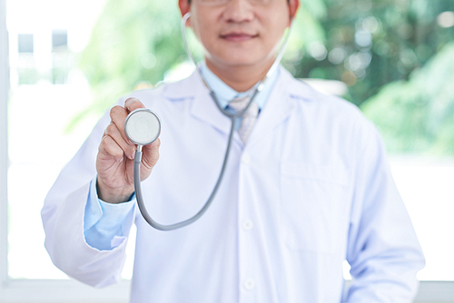 Cropped image of doctor in white coat with stethoscope