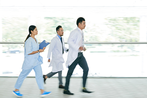 Doctors and nurse running to the patient, blurred motion