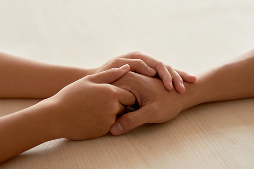 CLose-up image of hands of woman reassuring her boyfriend