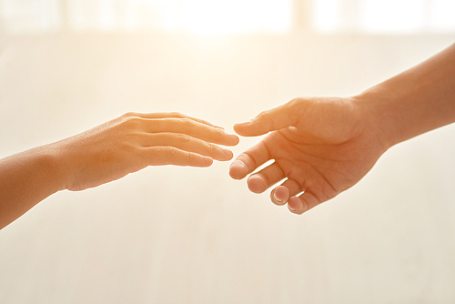 Hands of couple reaching for each other