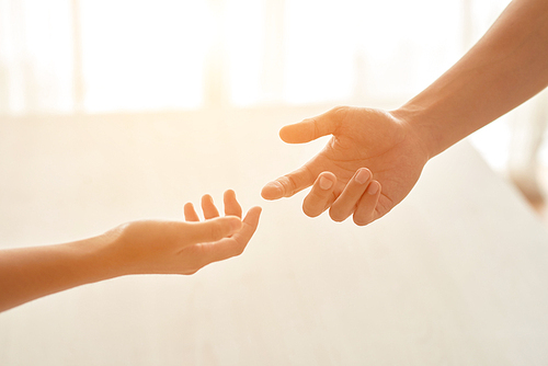 Outstretched hands of two people, selective focus