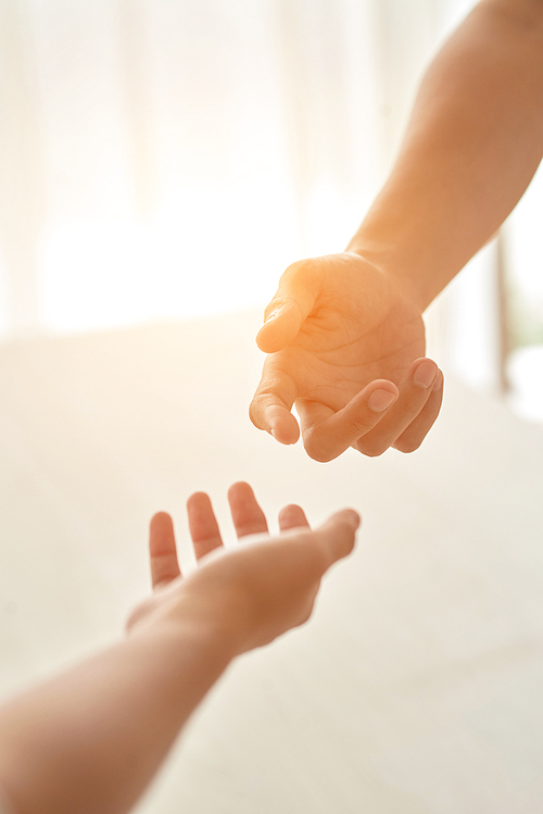 Male and female hands outstretched in direction to each other