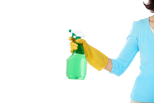 Unrecognizable housemaid wearing rubber gloves holding spray cleaner in hand while standing against white background, copy space