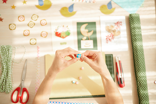 Hands of woman making greeting cards, view from above