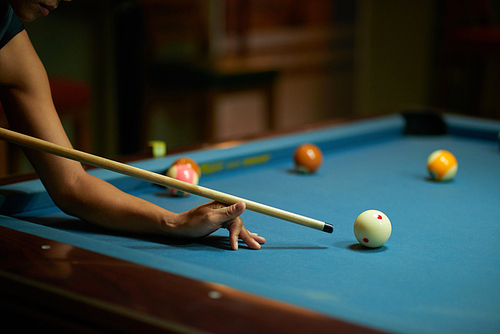 Cropped image of player hitting ball with a cue