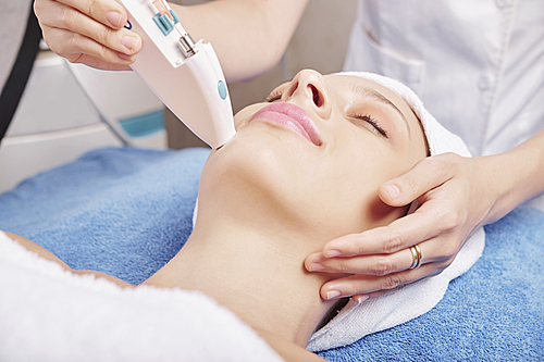 Close-up image of beautician making injections of skin boosters with vitamins