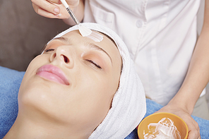 Close-up image of young woman enjoying beauty procedure in spa salon