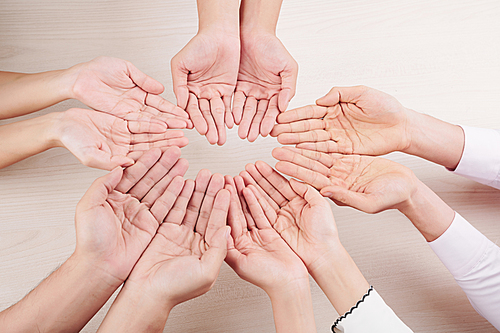 Close-up of family making circle from hands and showing support and love over white background