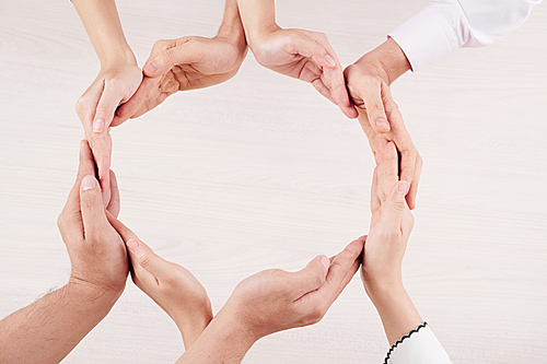 Close-up of family making circle from their hands and showing unity of their relationship isolated on white