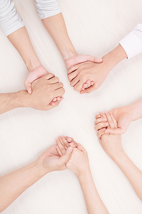 High view portrait of family holding hands and support each other isolated on white