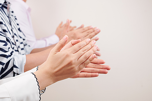 Close-up of business team standing and clapping hands they celebrating success of the business