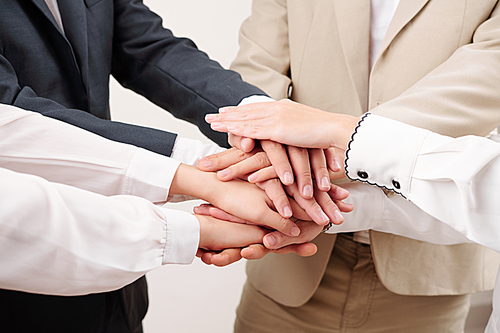Close-up of business people standing and holding hands they working in team and support each other in business