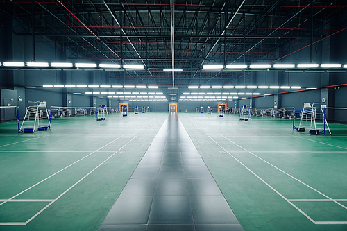 Empty gymnasium with courts for badminton and tennis competitions and training