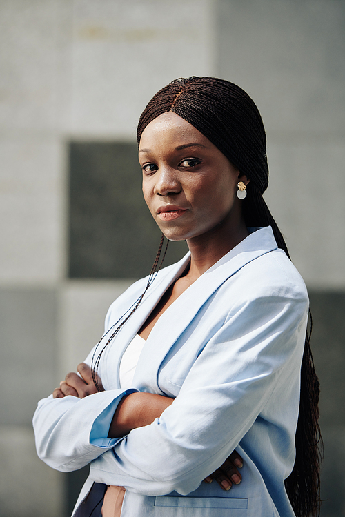 Serious young confident Black businesswoman folding arms and 