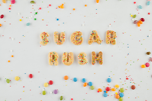 Sprinkled homemade cookies in form of letters making sugar rush inscription