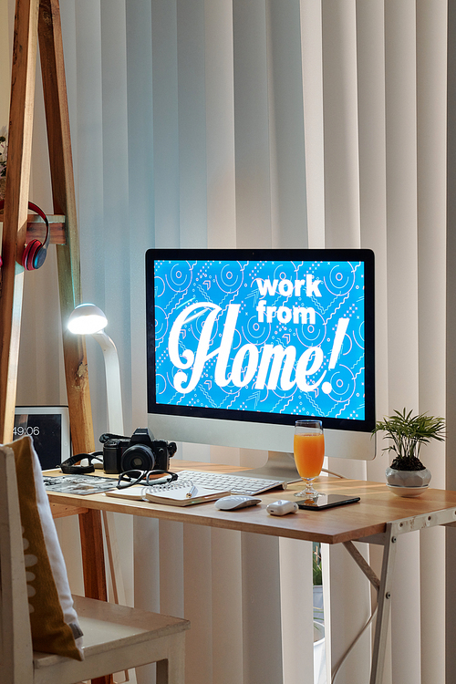 Work from home inscription on computer screen of photographer in his home office