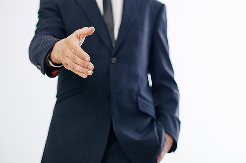 Cropped image of entrepreneur outstretching hand for handshake when greeting colleague